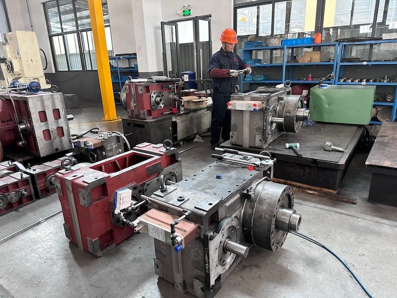A worker operates equipment to repair industrial gearbox. This image highlights industrial gearbox repair as part of KAIBO’s After-Sales Services, showcasing technical expertise and commitment to reliable product operation.